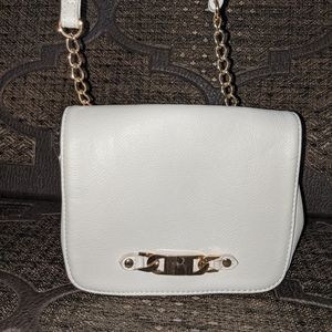 Small white purse with gold embellishment